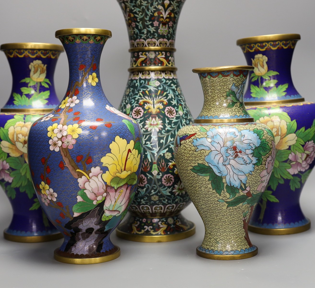 Seven Chinese cloisonné enamel vases and a bowl, tallest 39 cms high